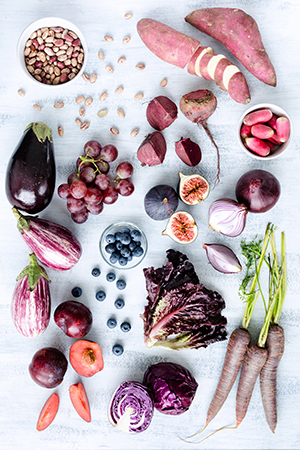 Assorted purple toned fruits and vegetables as a collection